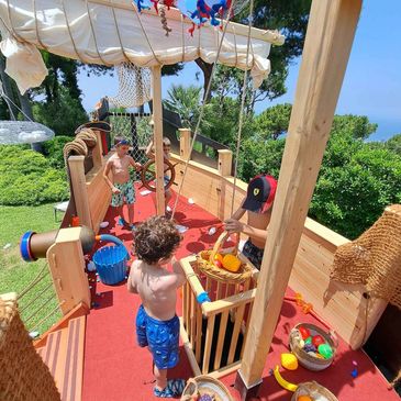 A group of kids playing on a ship game