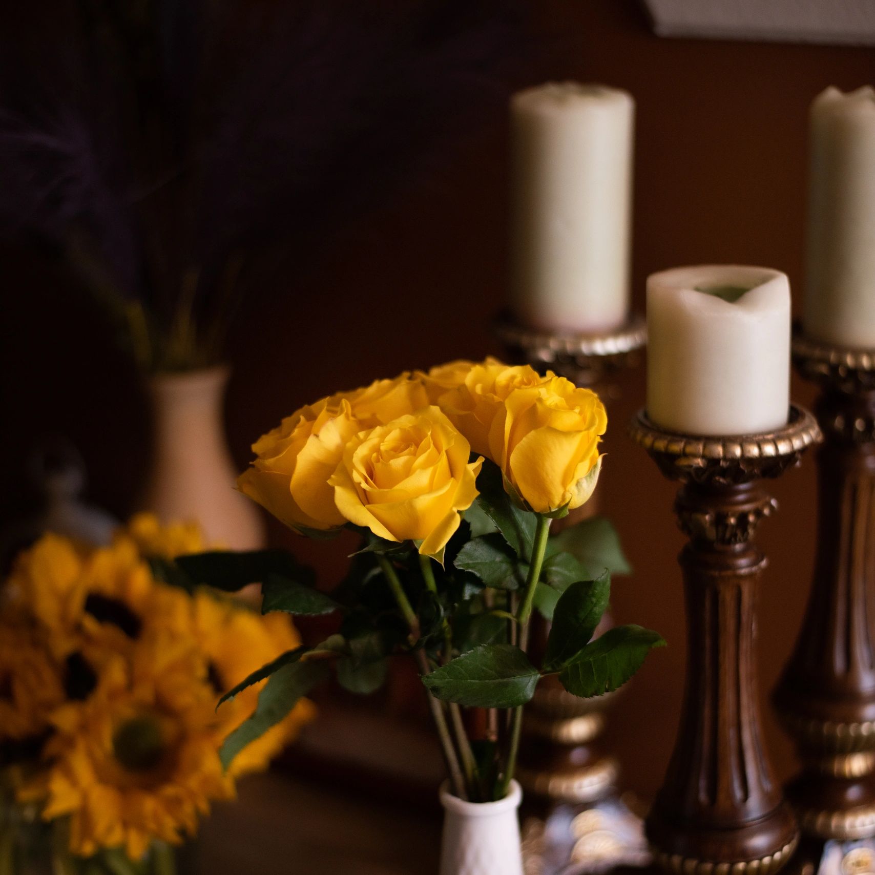 A picture of yellow roses, candles and sunflowers in Revivify's space.