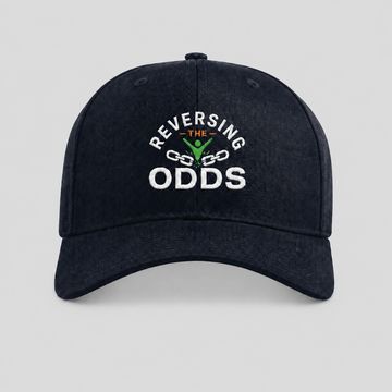 Black cap with 'Reversing the Odds' embroidered design and chain graphic.