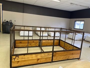 Wood and metal raised garden bed frame indoors.