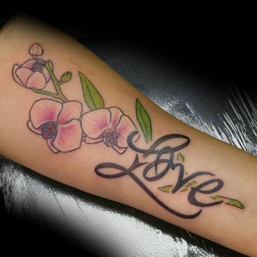 A colorful tattoo of pink flowers and the word 'Love' on forearm.