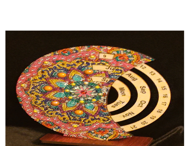 Colorful circular perpetual calendar with intricate patterns and date rings.