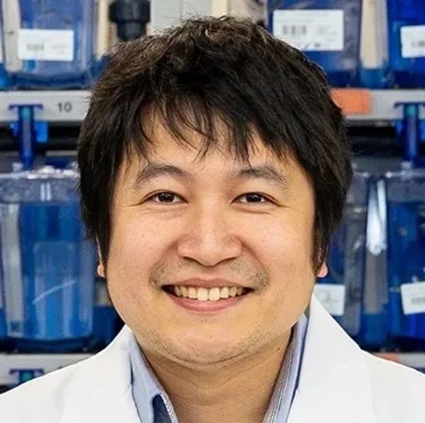Smiling man in a lab coat.