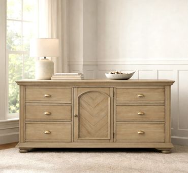 Wooden sideboard with drawers and a central cabinet in a bright room.