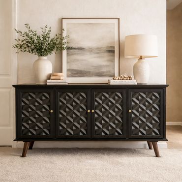 Elegant black sideboard with textured doors and decorative items on top.