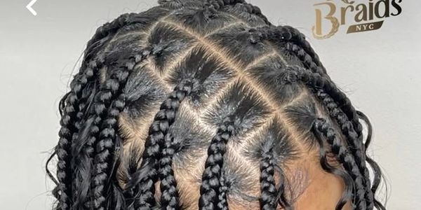 Close-up of neat box braids with a clean parting pattern.