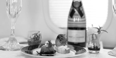 Elegant appetizers and champagne on a table, set for a refined dining experience.