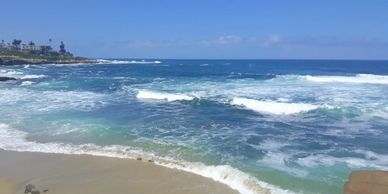 View of the the beach with blue and aqua waters.