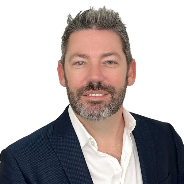 Professional man with beard in suit jacket and white shirt.