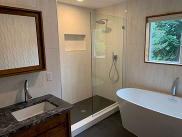 Remodeled bathroom including relocating sink, freestanding tub and shower.   