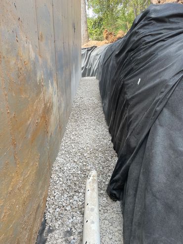 French Drain System, Footer Drainage. Wrapping drain like a burrito keeping out unwanted silt & snd 