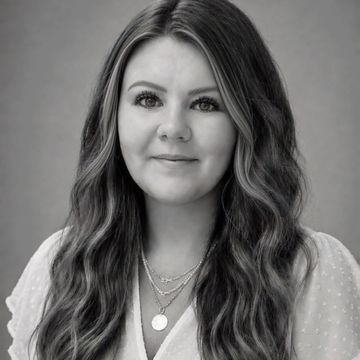 Black and white portrait of a woman with long wavy hair.