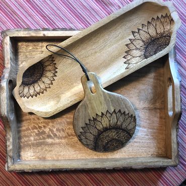 Mango wood trays with burned sunflower designs