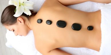 Lady getting a hot stone massage at The One Beauty & Spa Yarralumla Canberra
