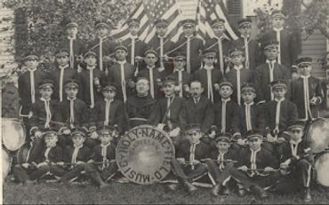 Vintage group photo of a youth band with instruments and flags.