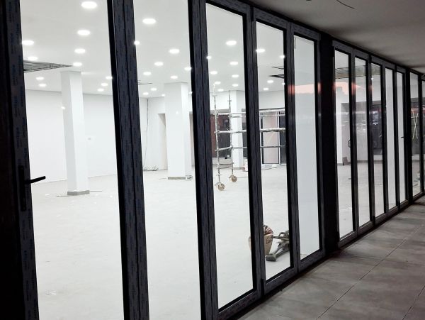 Empty room with glass doors and bright lights.