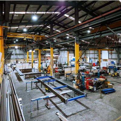 BC industrial worksite with cranes and heavy equipment, reflecting Estrea’s industrial HR consulting