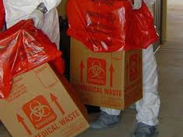 Hazmat crew packaging bloody biohazard waste for disposal