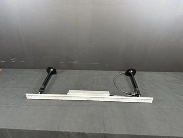 A black and white measuring tool with two legs on a table.