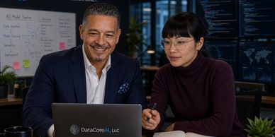 Two professionals collaborating over a laptop in a modern office.