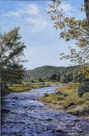 Serene river flowing through a lush, green landscape under a clear blue sky.