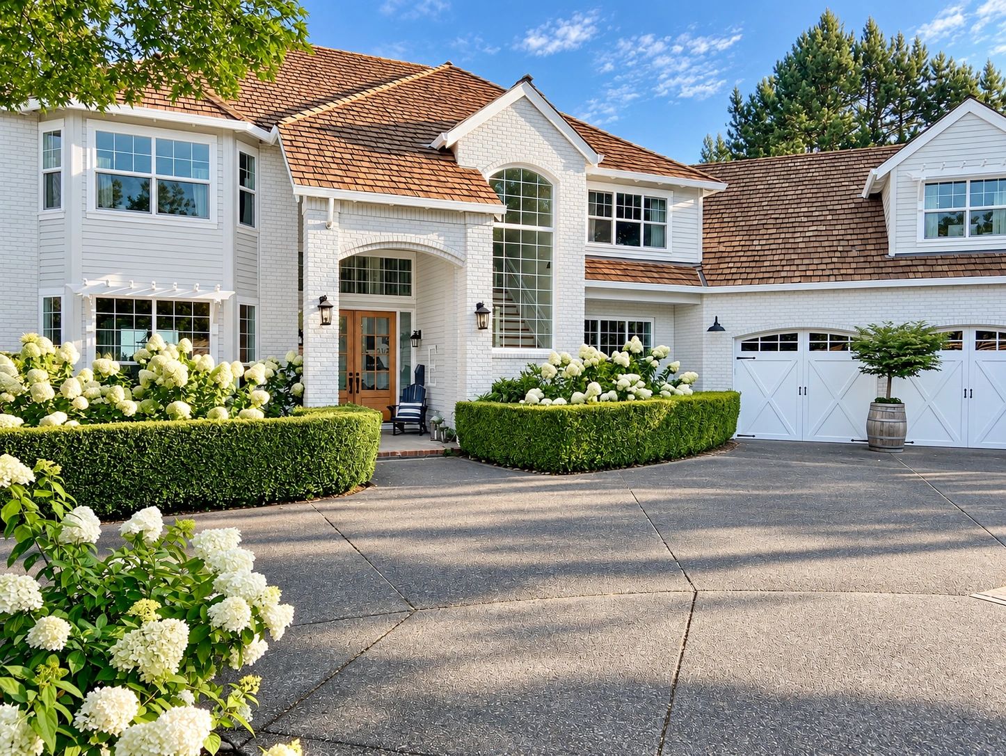 Beautiful white brick house with wooden roof and manicured garden.