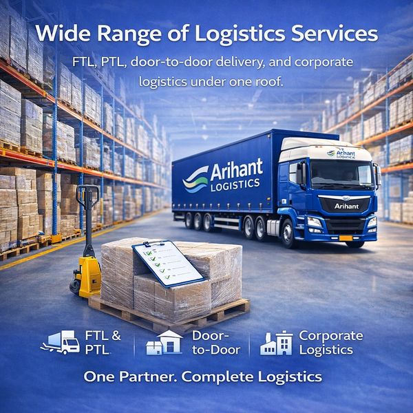 A logistics warehouse with stacked boxes and a blue Arihant Logistics truck.