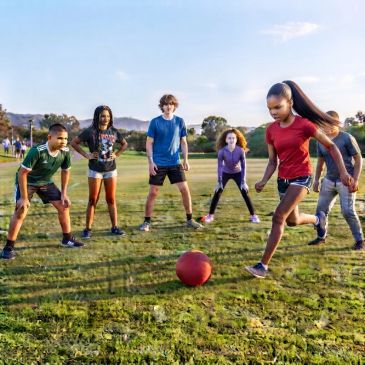 Kids playing soccer on a grassy field.