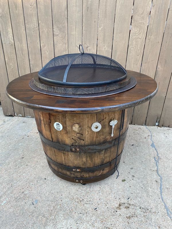 whiskey barrel fire pit 20 lb propane tank inside, drink ledge, flame screen, table top, casters