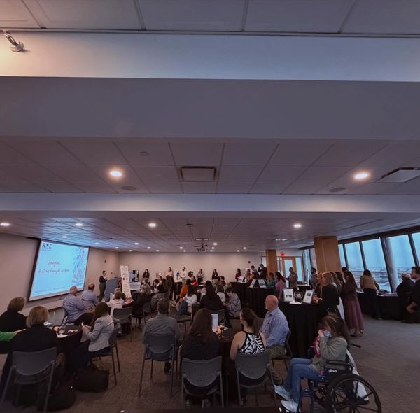 People attending a formal presentation in a conference room.