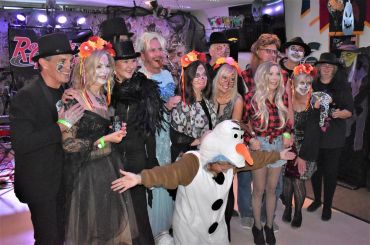 Group of people in costumes posing at a party.