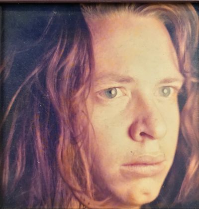 Close-up portrait of a person with long hair.