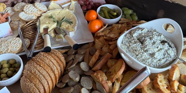 Grazing table with assorted, meats, cheese, crackers, bread and pasta - Century Farm Catering 
