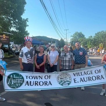 Aurora Town Council holding Town of Aurora banner at a Independence Day parade 2026.
