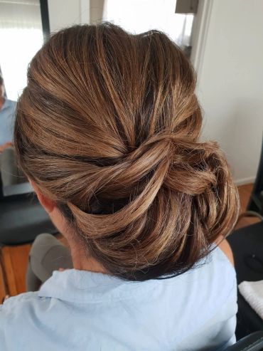 Elegant twisted low bun hairstyle.