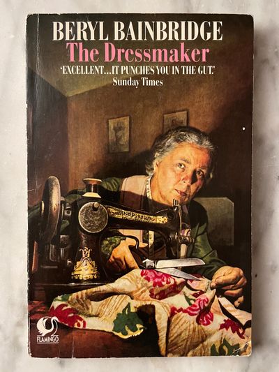 Colourful front cover of Beryl Bainbridge's The Dressmaker, depicting a woman with sewing scissors
