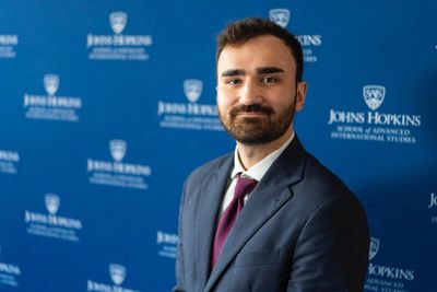 Professional portrait of a man in a suit at Johns Hopkins University.