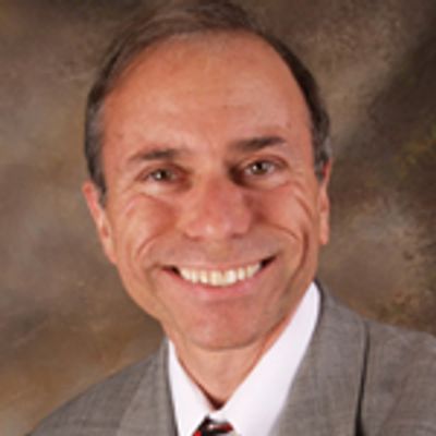 Portrait of a smiling man in a suit and tie.