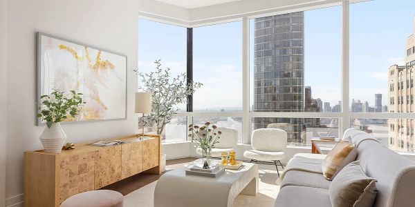 Bright modern living room with large windows and city view.