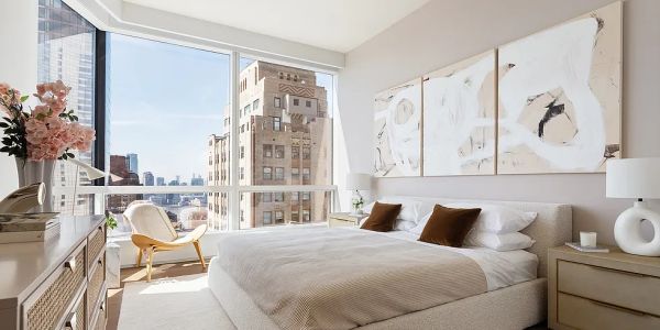 Bright modern bedroom with large window and city view.