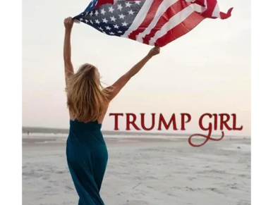 A woman walking on a beach holding an American flag that is blowing in the wind