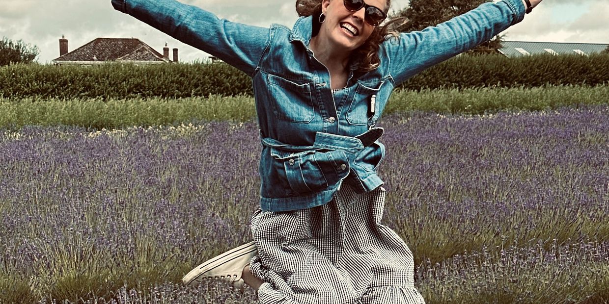 Founder of drbl, Immy jumping in the air with a field of lavender in the background.