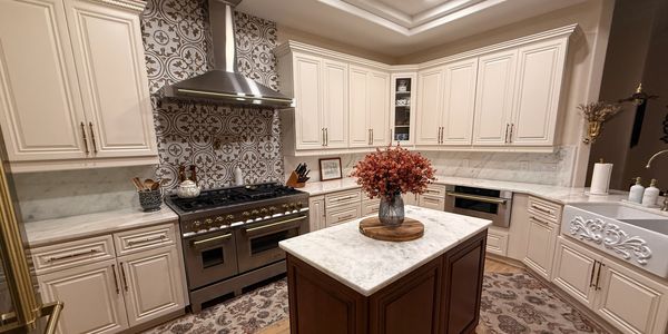 Elegant kitchen with cream cabinets and marble countertops.