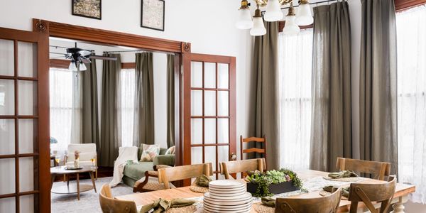 Elegant dining room with wooden furniture and large windows.