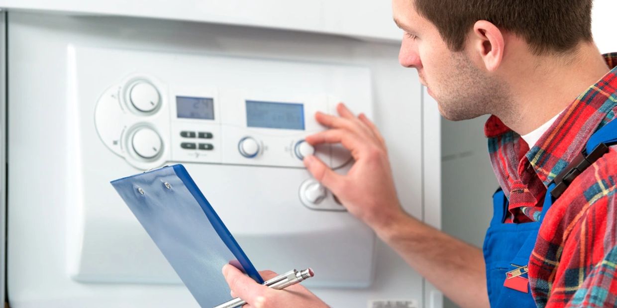 Technician servicing the gas boiler for hot water and heating