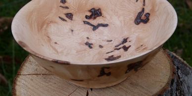 Wooden bowl with dark natural patterns.