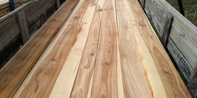 Stack of wooden planks inside a wooden frame.