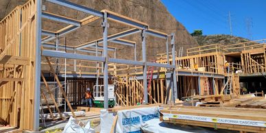 Wood framed house under construction on a clear day.
