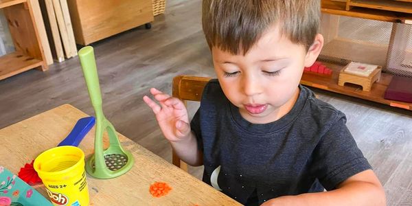 Little boy playing with playdoh