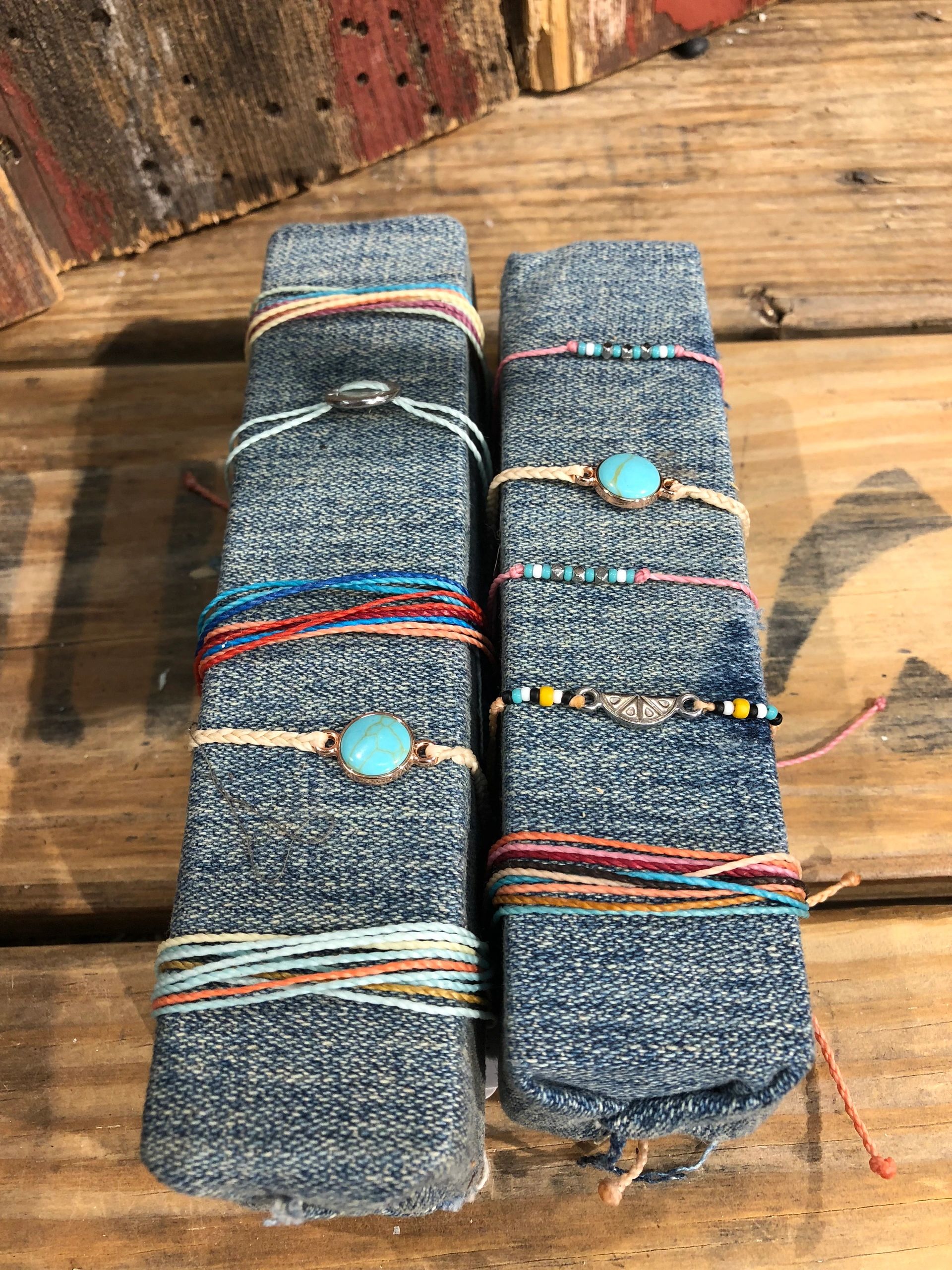 Colorful string bracelets with beads on denim display stands at The Peak in Albertville, MN